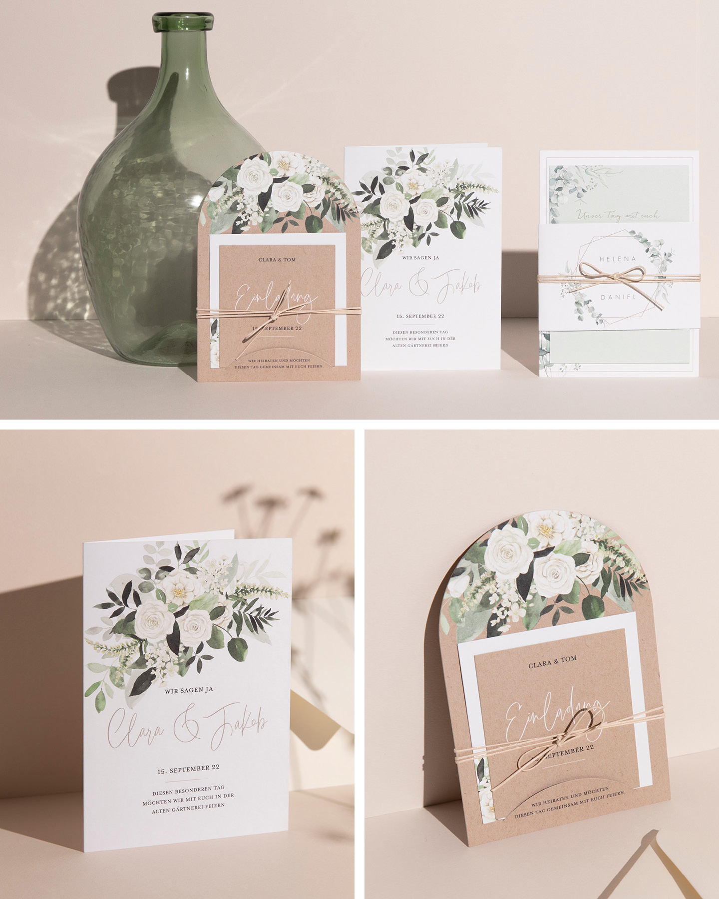 Drei Hochzeitseinladungen mit Greenery & weißen Blumen Illustrationen lehnen an hellem Hintergrund.